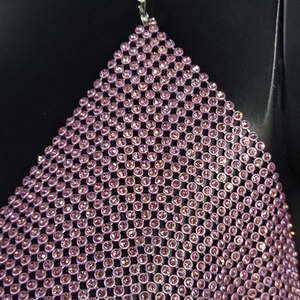 Close-up of pink rhinestone mesh fabric with sparkling metallic grid and crystal detail