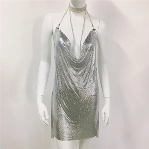 Detail view of silver chainmail dress showing metallic sequins and cowl neck design