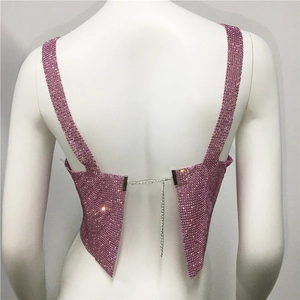 Detail view of pink rhinestone crop top with adjustable back metal chain and open back style