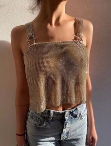Close-up of champagne gold chainmail mesh with sparkling rhinestones and metal buckle