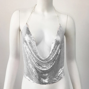 Detail of silver metallic sequin halter top featuring fine mesh and deep V-neckline
