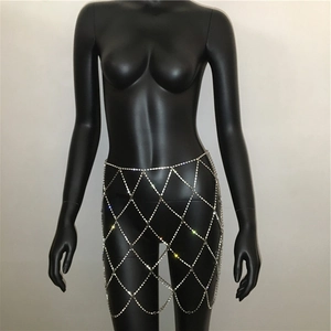 Detail of silver rhinestone body chain featuring a geometric diamond mesh pattern