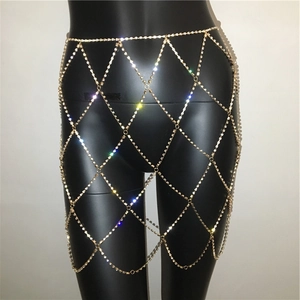 Detail of gold rhinestone body chain skirt with hollow rhombus mesh and tassels