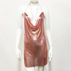 Macro shot of rose gold chainmail texture and delicate metal sequin details on the dress