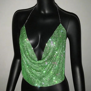 Detailed close-up of emerald rhinestone mesh crop top with silver metal neck chains