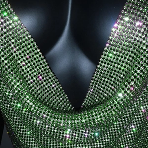Macro shot of emerald green rhinestone mesh tank top with deep V-neck and sparkling crystals