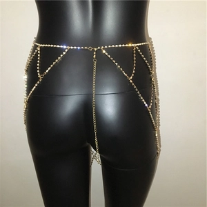 Close-up of golden rhinestone waist chain with multi-layer fringe and adjustable links