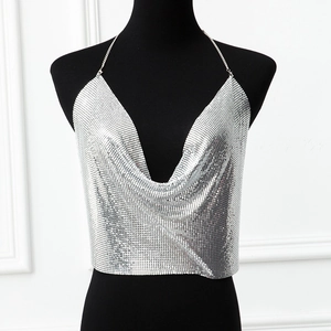 Close-up of sexy silver metal sequin mesh halter top with deep V-neck and reflective glint