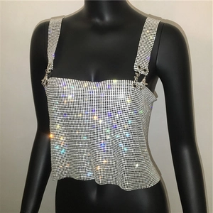 Detailed view of silver rhinestone mesh crop top with sparkling metallic texture and buckles