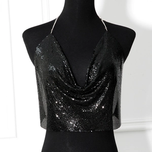 Macro detail of black sequin mesh top with metallic chain halter neck and draped v-neckline