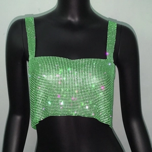 Λεπτομερής προβολή του πράσινου crop top με λαμπερά στρας και υφή από παγι αστραφτερές πούλιες