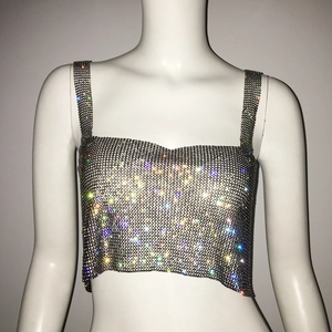 Macro view of silver rhinestone crop top with metallic mesh texture and shiny finish