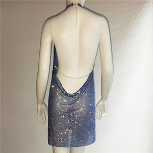 Macro detail of sparkling blue rhinestone fabric and backless halter design on a party dress