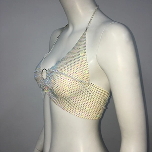 Macro shot of colorful rhinestones and silver metal ring detail on the halter top