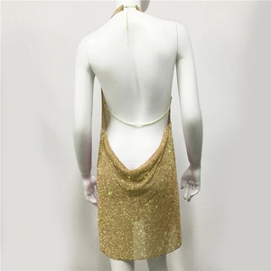 Detail of gold sequin mini dress featuring backless halter design with thin metal chains