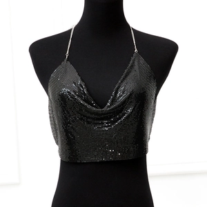 Detail of black metal mesh sequins and silver chain straps on a cowl neck crop top