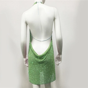 Detailed back view of a green rhinestone halter dress featuring metallic chains and open back