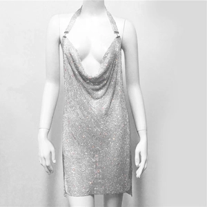 Macro detail of silver sequin metal mesh fabric with sparkling rhinestones for party dress