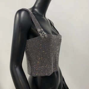 Close-up of sparkling silver rhinestone crop top with metallic ring shoulder straps