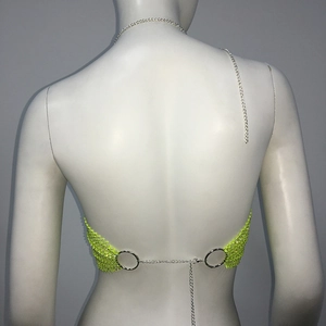 Detail view of fluorescent yellow rhinestone mesh bikini top with silver metal chains