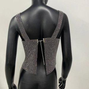 Close-up of sparkling rhinestone top with intricate back metal chain buckle detail