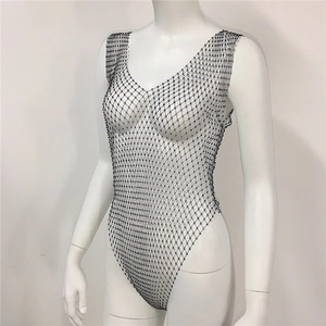 Close-up of black mesh bodysuit featuring sparkling rhinestones and open fishnet design