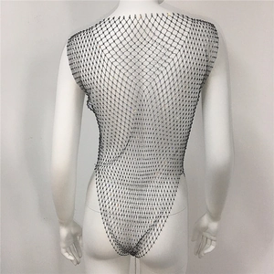 Detail of black fishnet bodysuit with sparkling rhinestones and open back design