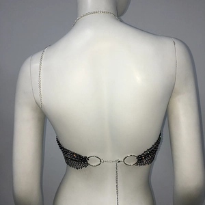 Macro view of black mesh bralette with rhinestones and adjustable silver chain