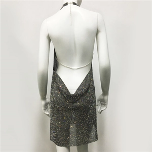 Detailed back view of silver sequin halter dress featuring a delicate metal chain strap