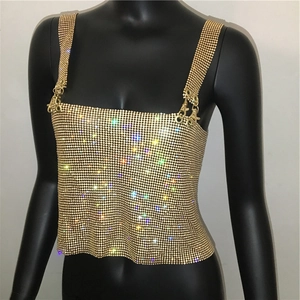 Detailed close-up of shiny gold metallic mesh halter top with sparkling sequin texture