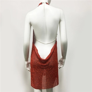 Detail view of the red sequin dress with backless design and adjustable metal chains