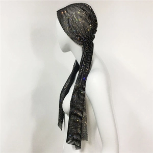 Close-up of black mesh headscarf with glittering colorful rhinestones on a mannequin