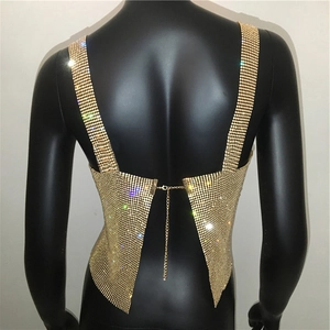 Close-up of golden rhinestone metal mesh backless top with adjustable chain link closure