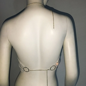 Detailed back view of gold chain halter neck top featuring sparkling white rhinestone mesh
