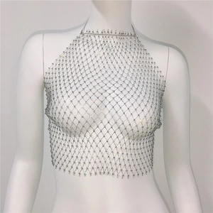 Macro detail of sparkling silver rhinestone mesh halter top with metallic chain grids