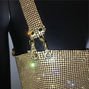 Close-up of golden rhinestone mesh top featuring metal lobster clasp and eyelet detail