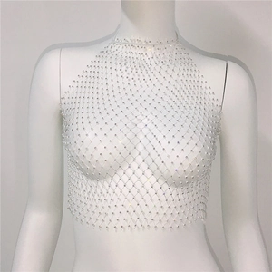 Close-up of white mesh halter top with sparkling rhinestones for party wear