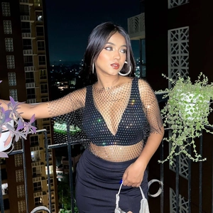 Close-up of sexy black fishnet top with rhinestones and deep V-neck for festivals