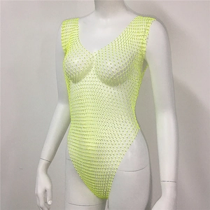 Detailed view of neon yellow mesh bodysuit featuring sparkling rhinestones and a V-neck