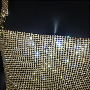 Detail of gold metal mesh top featuring sparkling white rhinestones and secure clasp