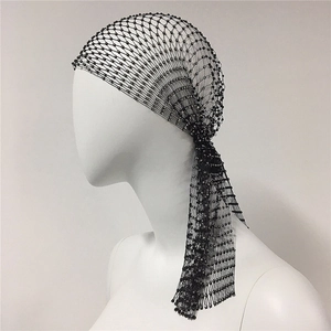 Close-up of black elastic fishnet headband with silver rhinestones and side tassels