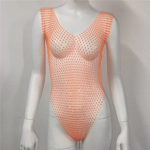Detailed macro view of orange rhinestone fishnet bodysuit with V-neck and mesh texture