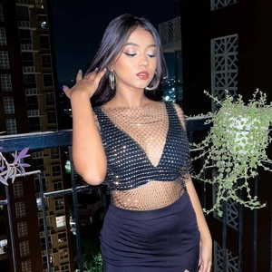 Detailed view of women's black mesh fishnet top with sparkling silver rhinestones