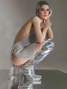 Futuristic silver mirror over-the-knee boots with matching metallic sequin dress