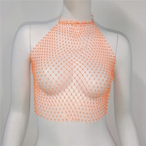 Detail of orange mesh halter top with sparkling rhinestones and elastic knit texture