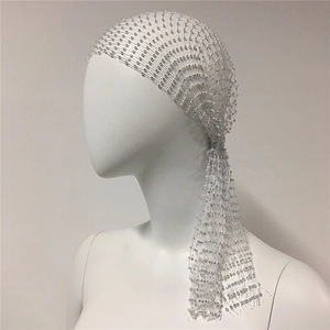 Macro detail of white mesh headpiece with crystal rhinestones and long tassel fringe