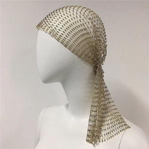 Detailed side view of golden rhinestone mesh headpiece with sparkling long fringes