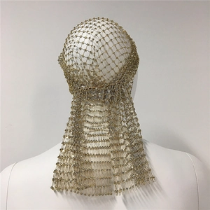 Close-up of gold metal mesh headpiece with sparkling rhinestones and long tassel fringe