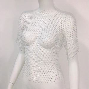 Macro shot of white mesh fabric texture with sparkling rhinestones and crystal details