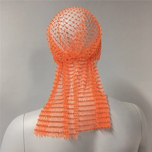 Detail of bright orange elastic mesh headwear with sparkling rhinestones and hex grid
